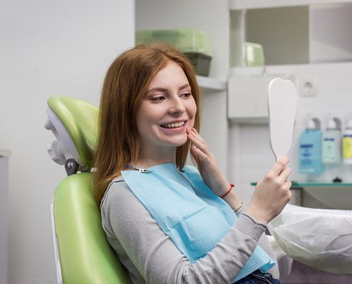 Dentist examining girl's teeth in clinic. Dental problem. Healthy Smile.